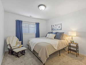 Bedroom with baseboards and light colored carpet
