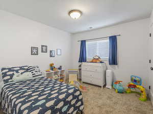 Carpeted bedroom with baseboards