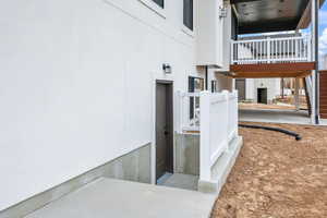 Entrance to property featuring stucco siding