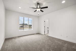 Carpeted empty room featuring recessed lighting and a ceiling fan