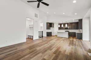 Unfurnished living room with ceiling fan, light wood-style flooring, lofted ceiling, and recessed lighting