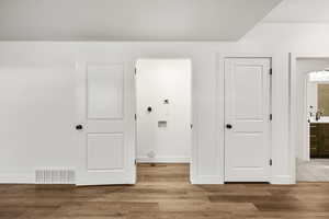 Laundry area featuring light wood-style flooring
