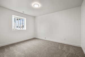 Spare room with carpet floors and a textured ceiling