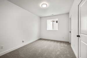 Unfurnished bedroom featuring light carpet and a textured ceiling