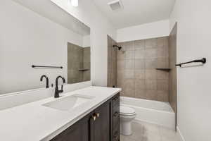 Full bathroom featuring vanity,  shower combination, and light tile patterned floors