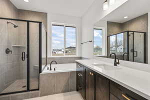 Full bathroom featuring vanity, a stall shower, a garden tub, recessed lighting, and light tile patterned floors