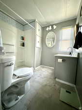 Bathroom featuring vanity, a shower stall, and ornamental molding