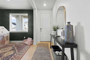 Foyer featuring light wood-style flooring and recessed lighting