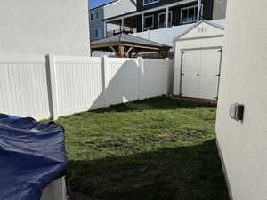 Fenced backyard with a storage shed