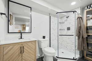 Bathroom featuring vanity and tiled shower