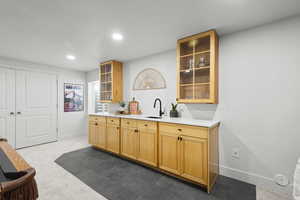 Wet bar featuring glass fronted cabinets