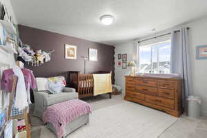 Bedroom featuring mauve scalloped accent wall