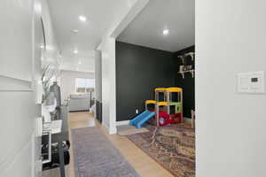 Playroom/offic space with light wood-type flooring and recessed lighting