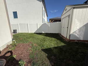 Fenced backyard with a shed