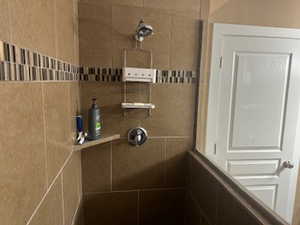 Bathroom featuring tiled shower