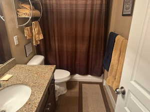 Bathroom featuring vanity and dark tile patterned flooring
