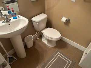 Bathroom with toilet and baseboards