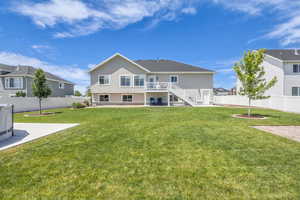Rear view of house with a patio, a fenced backyard