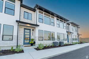 Contemporary house featuring stone siding and stucco siding