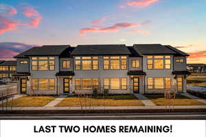 View of front facade featuring stucco siding, a standing seam roof, and a shingled roof