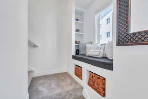 Beautiful bay window with custom shelving perfect for a reading nook with entry to the upper levels