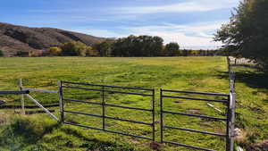 Gate featuring a rural view and a mountain view