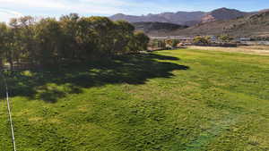 View of green lawn featuring a mountain view