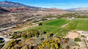 Overview of rural landscape with mountains and rows of crops