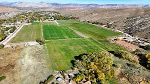 Aerial view of sparsely populated area with farmland and mountains
