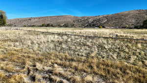 View of mountain backdrop with rural landscape