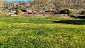 View of yard featuring a view of rural / pastoral area and a mountain view