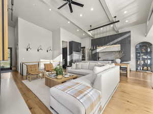 Living room with light wood-style flooring and a ceiling fan