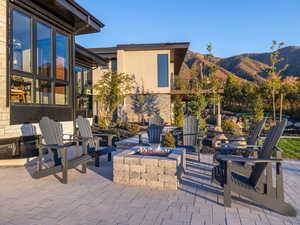 View of patio with a fire pit and a mountain view