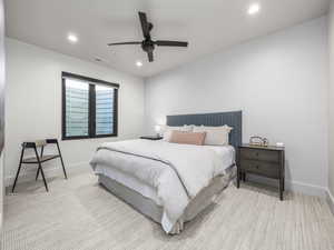 Carpeted bedroom featuring ceiling fan and recessed lighting