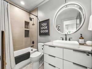 Full bathroom featuring vanity and shower / tub combo with curtain