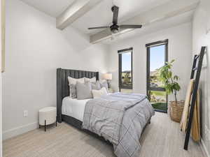 Bedroom with carpet, beam ceiling, and a ceiling fan
