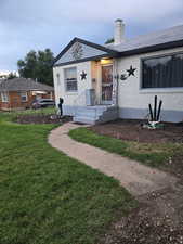 View of front of home featuring a front lawn and a chimney