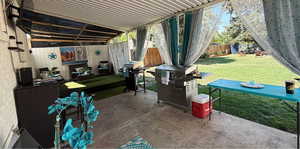 Fenced backyard featuring a patio area and grilling area