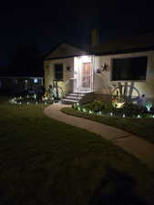 View of front of house featuring a lawn and a chimney