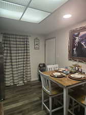 Dining space with dark wood finished floors and baseboards