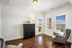 Living area featuring hardwood / wood-style flooring and baseboards