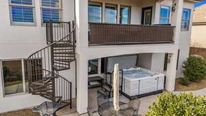 Patio / terrace featuring a hot tub and stairs
