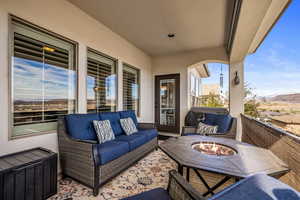 Patio / terrace featuring an outdoor living space with a fire pit and a mountain view