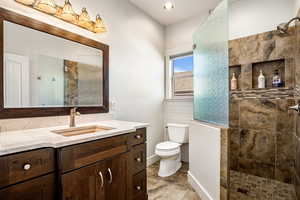 Full bathroom featuring a walk in shower and vanity