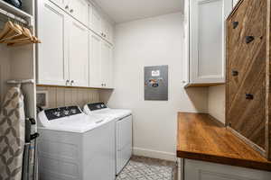 Laundry area featuring cabinet space and washing machine and dryer