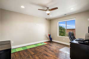 Office featuring dark wood finished floors, ceiling fan, and recessed lighting