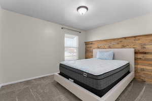 Carpeted bedroom with baseboards