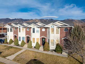 View of front of house with brick siding and a mountain view