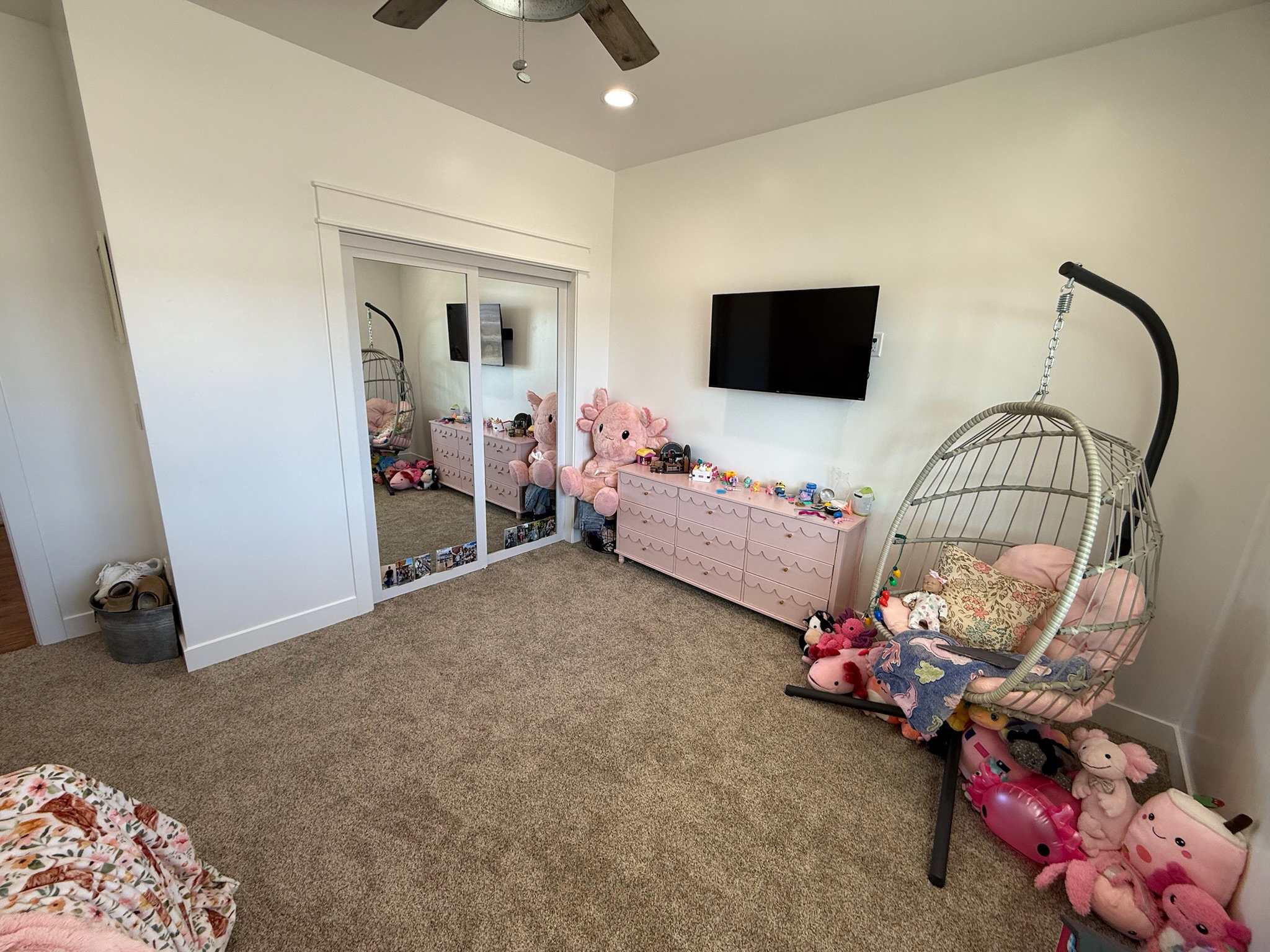 Spacious room featuring neutral carpet flooring and white walls