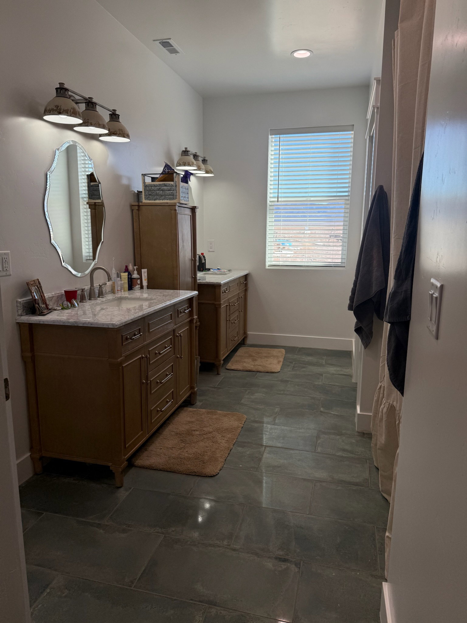 Dual vanity setup with stone countertops and undermount sinks